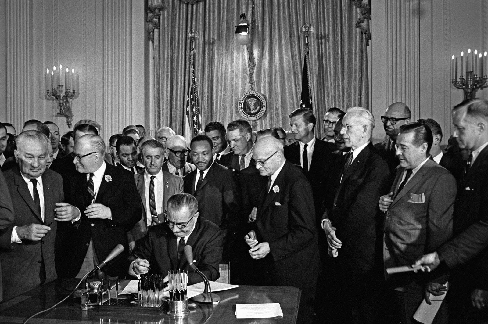 U.S. Pres. Lyndon B. Johnson signing the 1964 Civil Rights Act as Martin Luther King, Jr., and others look on, Washington, D.C., July 2, 1964